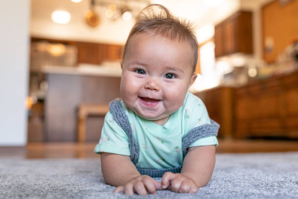 Baby laying on carpet floorings | Lake Forest Flooring